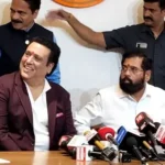 Govinda addressing a crowd during a political rally, exuding confidence and charm.